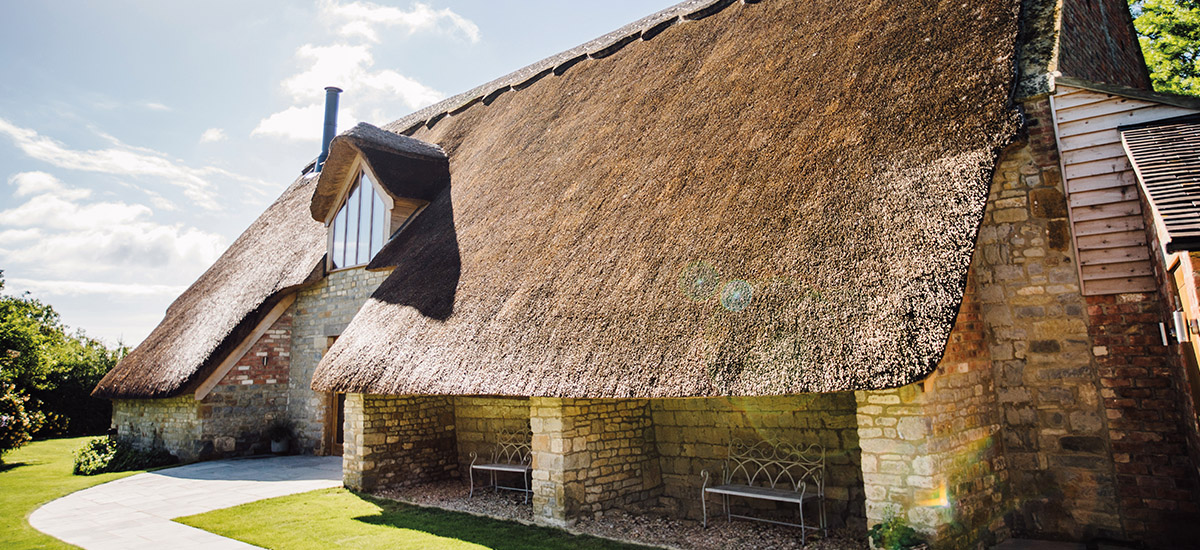 The exquisite Thatch Barn with exposed brick and exposed beams is a romantic space to say I do